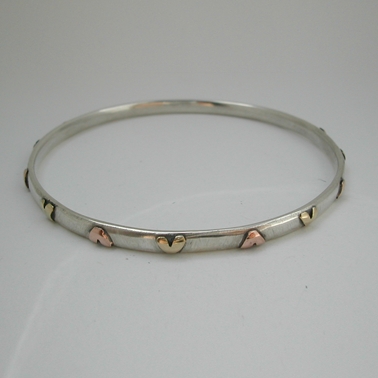 Bangle with brass and 9ct rose gold hearts